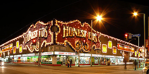 Image of Honest Ed's building lit up at night.