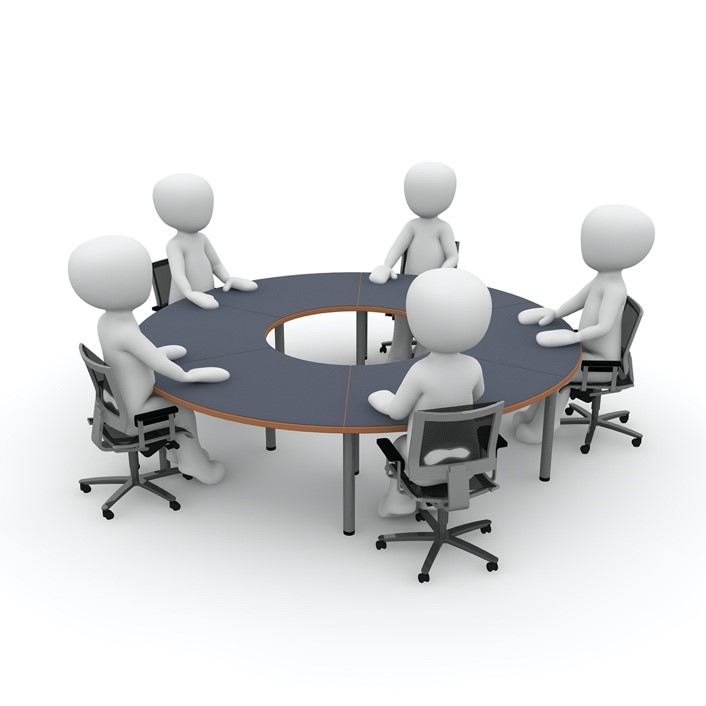 A group of people sitting around a table

Description automatically generated with medium confidence