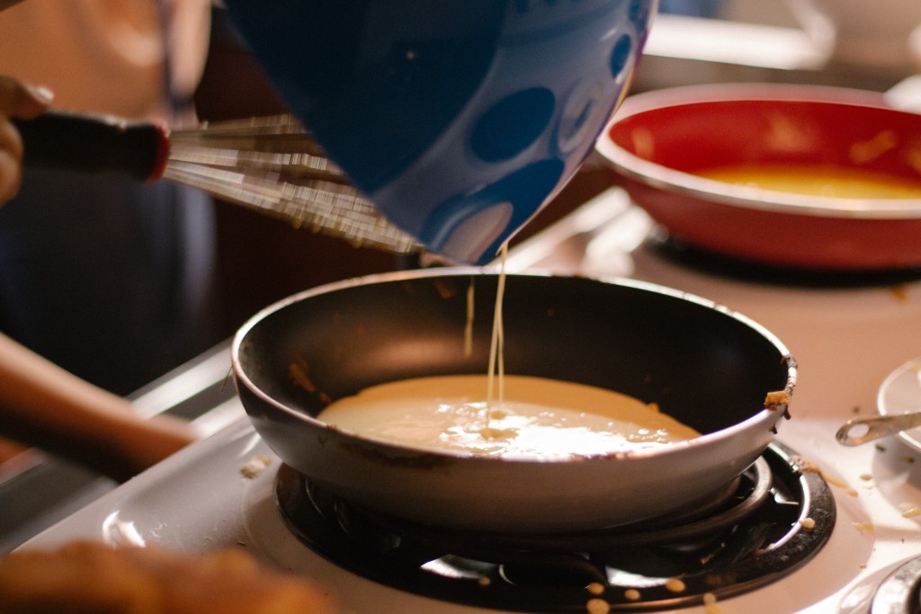A picture of pancake batter in a frying pan.