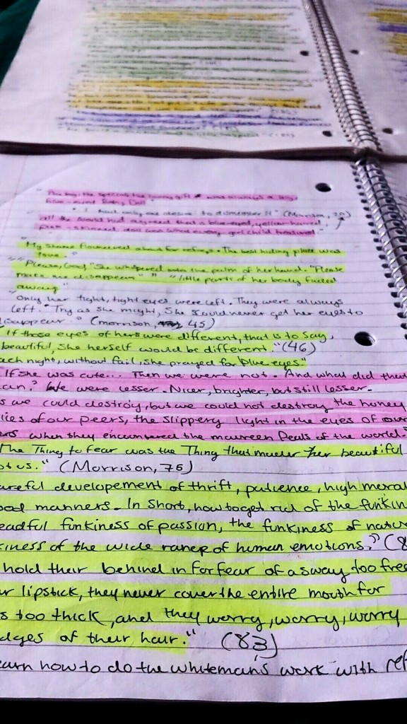 a notebook page littered in writing and highlighted in many different colors