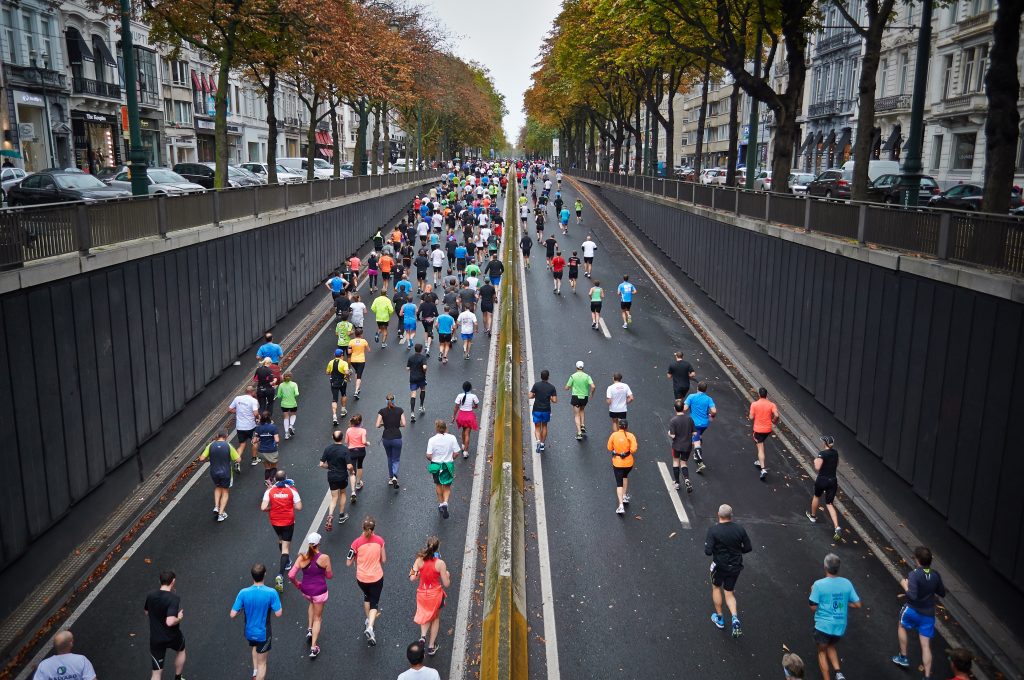 A group of runners head down a street.