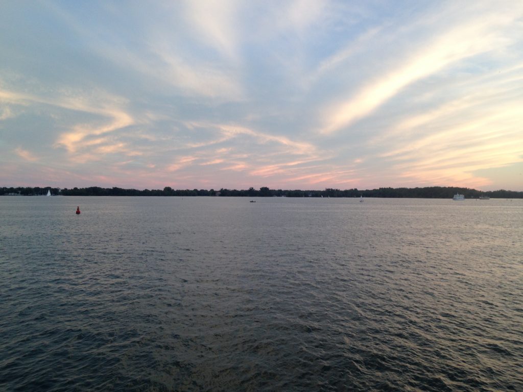 a view of ontario lake during sunset taken at the harbourfront