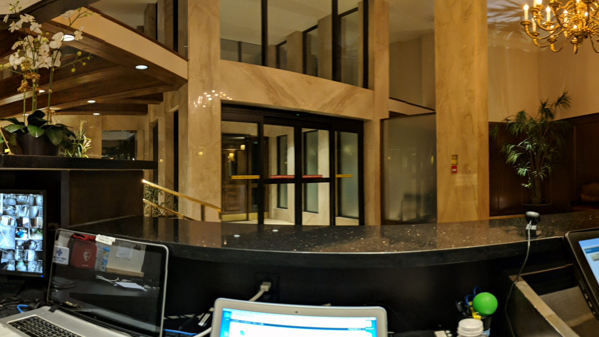 An image of an empty condo building lobby from the perspective of a security desk.