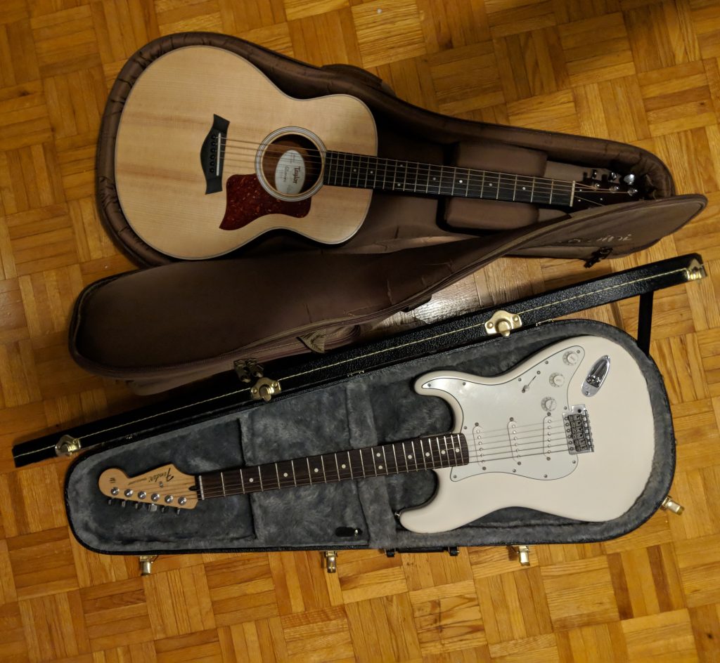 An image of a white electric guitar and a spruce top acoustic guitar