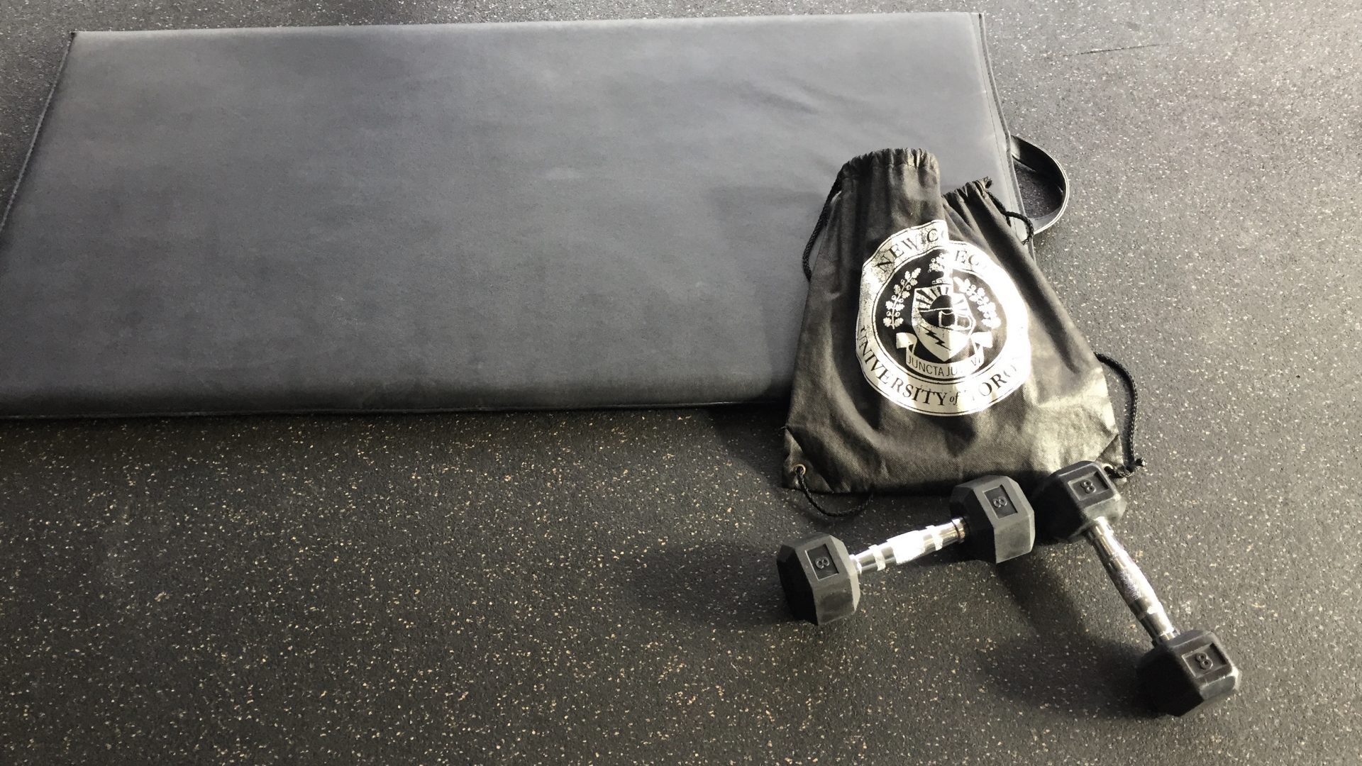 Workout mat, dumbbells, and gym bag