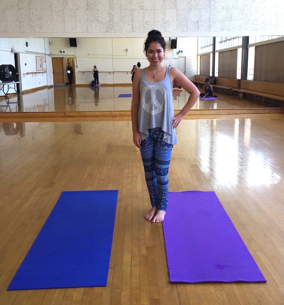 Author standing on a yoga mat in the dance studio