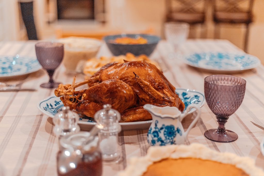 Turkey on a dinner table with table settings.