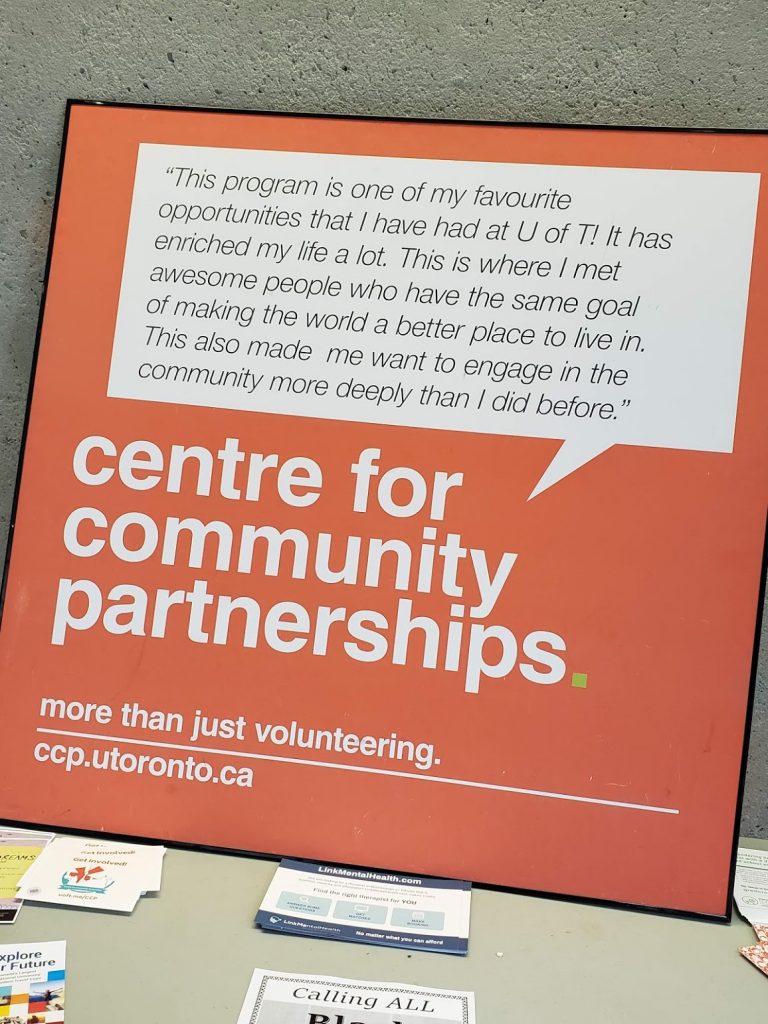 An orange and white poster with text, title being: "centre for community patnerships"