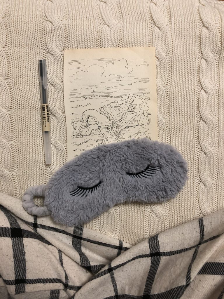 Sleep mask and image of sleeping griffin from Alice in Wonderland.