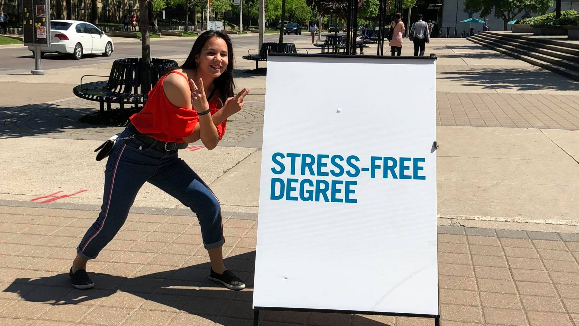 Future student in front of "stress-free degree" sign