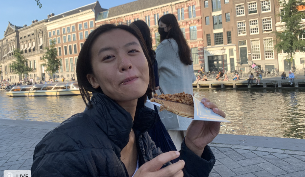 cheryl eating a waffle by the canal