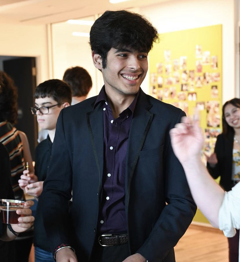 Photo of Yashvit smiling surrounded by other students
