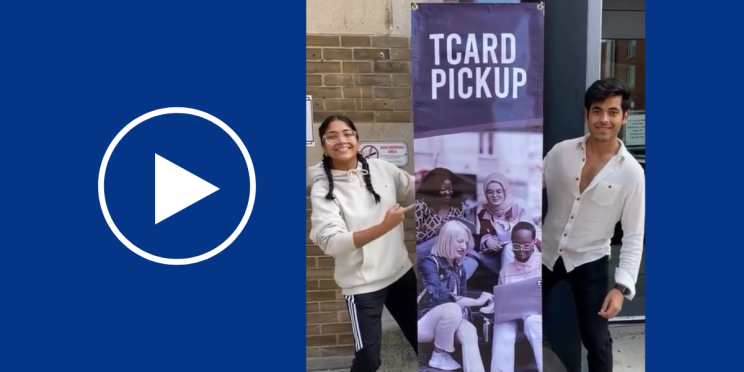 Anisha and Yashvit pointing at a sign that says TCard Pickup